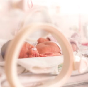 Premature newborn  baby girl in the hospital incubator after c-section in 33 week